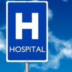 Hospital board traffic sign over blue sky background